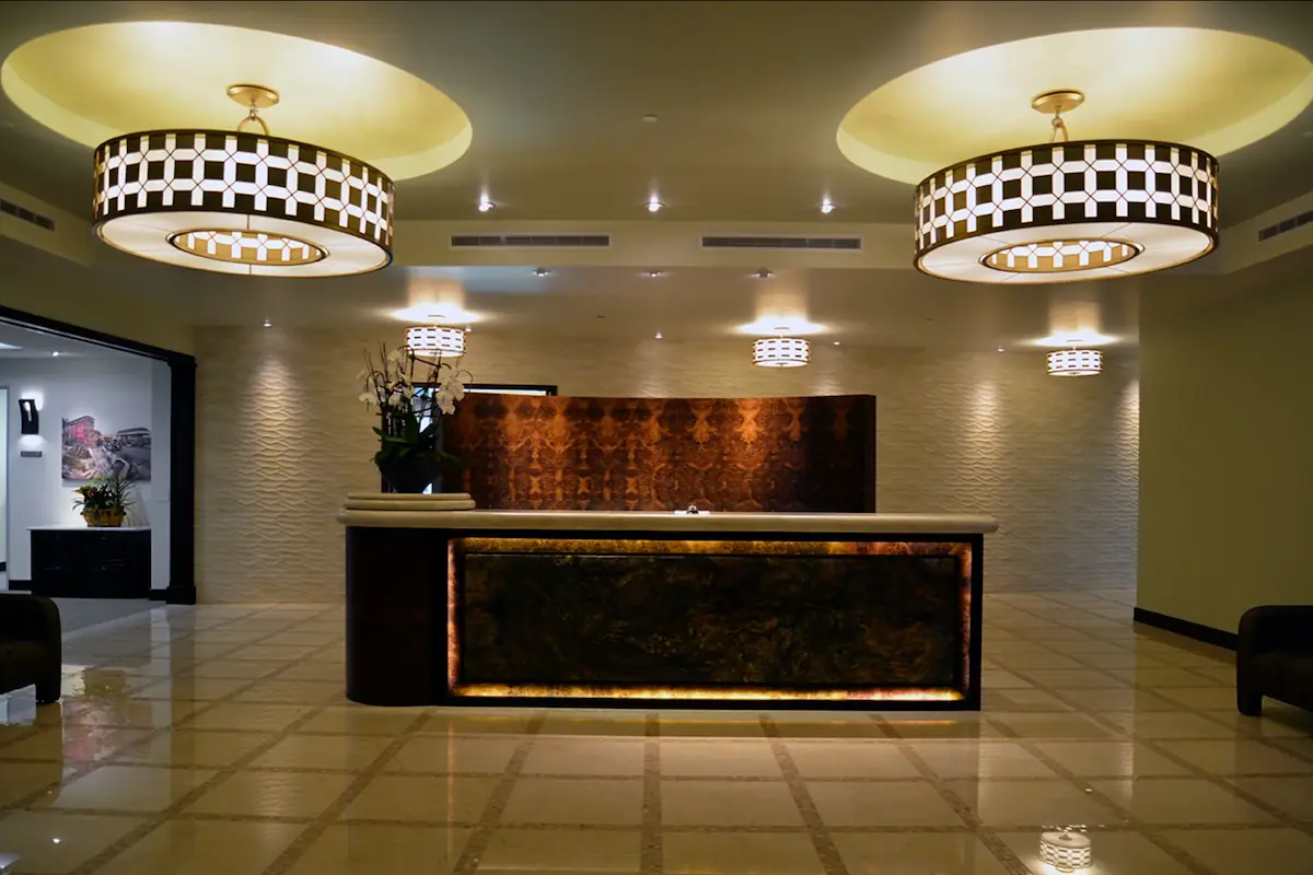 A lobby decorated with stone, facing the receptionist desk