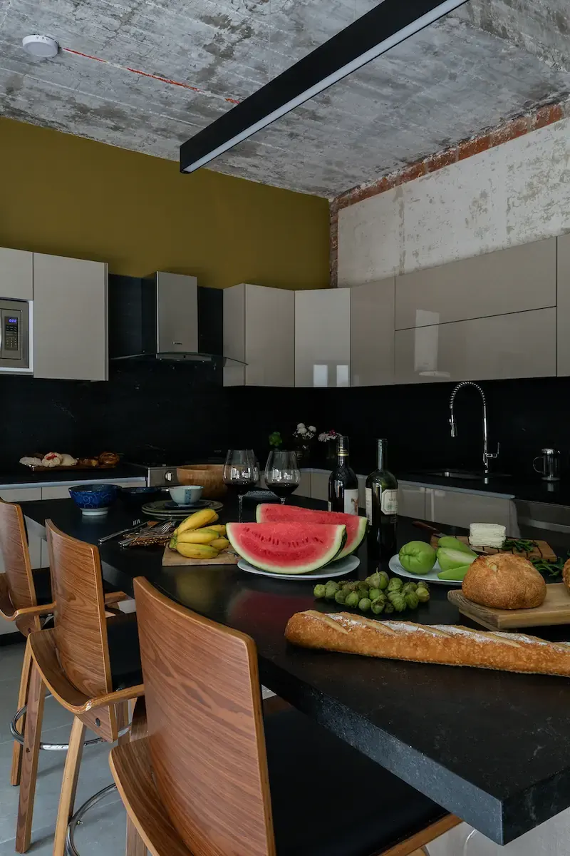 A dining table covered in food, made out of dark stone