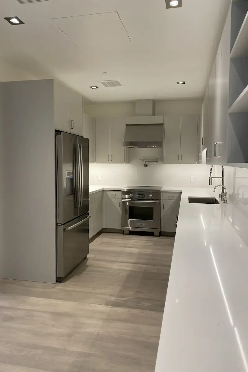 A kitchen with white stone countertops